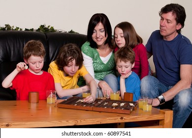 Big Family Is Playing A Boardgame In The Livingroom