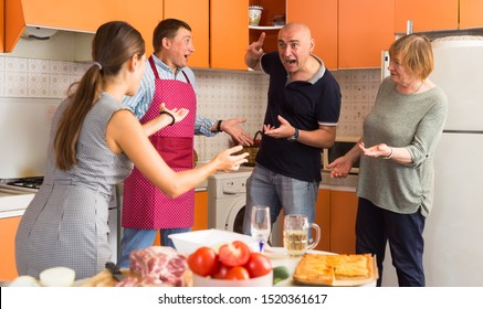 Big Family Quarrel. Two Women And Two Men Quarreling In Home Kitchen

