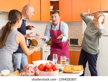 Big Family Quarrel. Two Women And Two Men Quarreling In Home Kitchen

