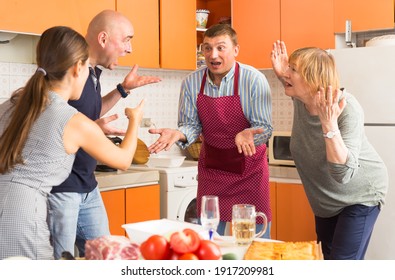 Big Family Quarrel. Two Women And Two Men Quarreling In Home Kitchen..