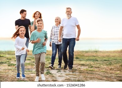 Big Family Resting Together In Park