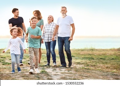 Big Family Resting Together In Park