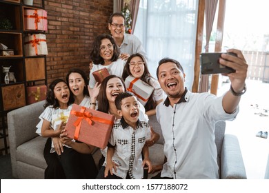 Big Family Selfie On Christmas Day. Asian People Take Picture Using Mobile Phone