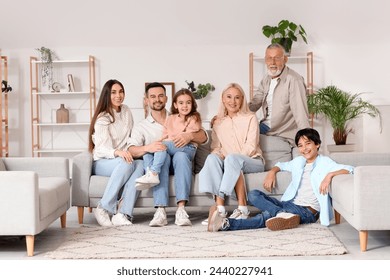 Big family sitting on sofa at home