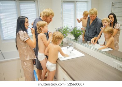 Big Family with Three children In Bathroom Brushing Teeth