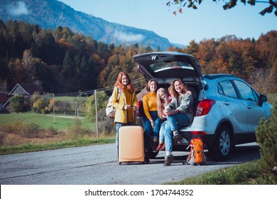 Big Family Trip - Happy Girls Travel By Car. Mamma With Daughters Sitting In The Boot
