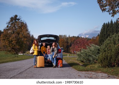 Big Family Trip - Happy Girls Travel By Car. Mamma With Daughters Sitting In The Boot
