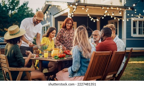 Big Family Vegetarian Party Gathered Together at a Table with Relatives and Friends. Young and Senior People are Eating Vegan Food, Drinking, Passing Dishes, Joking and Having Fun. - Powered by Shutterstock