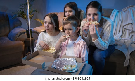 Big Family Watching Late Night TV Show Or Movie On Sofa And Eating Pizza And Popcorn.