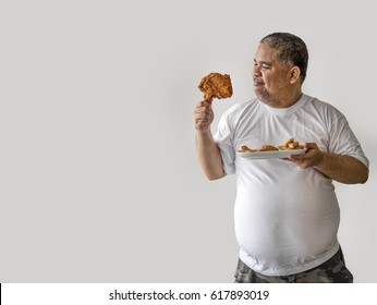 Big fat man with fried chicken for healthy background with space for text
