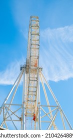 A Big Ferris Wheel Over Blue Sky In The Summer. Front View