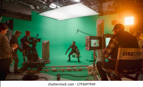 In the Big Film Studio Professional Crew Shooting Blockbuster Movie. Director Commands Cameraman to Start shooting Green Screen CGI Scene with Actor Wearing Motion Capture Suit and Head Rig - Shutterstock ID 1793697949