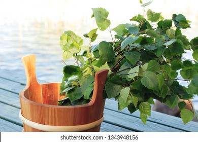 Big Finnish Sauna Whisk In Wooden Pail On Wooden Bridge At The Water