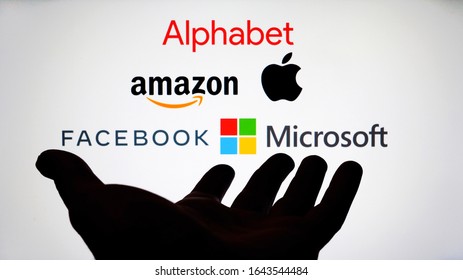 Big Five companies. Big Tech company logos: Alphabet, Amazon, Apple, Facebook, Microsoft on a screen and a silhouette of hand. Not a montage. Digital tax, antitrust. Stafford, UK - February 12 2020.