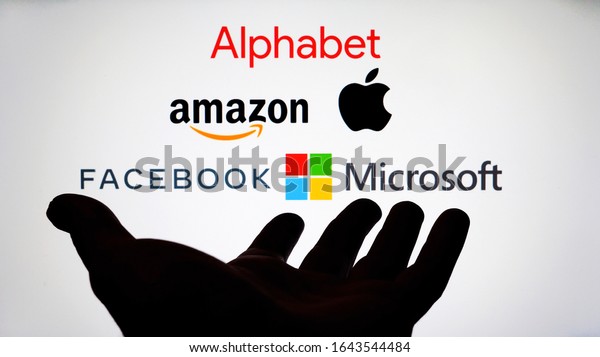 Big Five companies. Big Tech company logos:
Alphabet, Amazon, Apple, Facebook, Microsoft on a screen and a
silhouette of hand. Not a montage. Digital tax, antitrust.
Stafford, UK - February 12
2020.