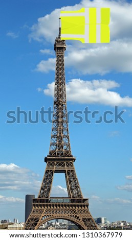 Big flag like a jackets symbol of Yellow vests movement on Eiffel Tower in Paris seen from the Trocadero