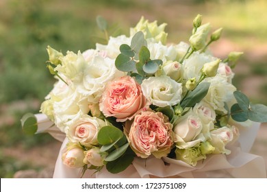 Big flowers arrangement in a wooden hat box was created by a florist for a wedding gift. White Freesia , 
eustoma flowers, roses and eucalyptus in a bouquet. Mother's Day Gift