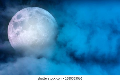 Big full moon with moon light covered by clouds in dark night sky, magic night time, space for text