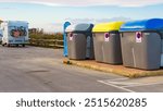 Big garbage plastic bin and camper, recreational vehicles on seaside rest area, public place in Spain.