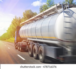 big gas-tank truck goes on highway against the sky