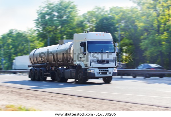 big gas-tank truck goes on\
highway