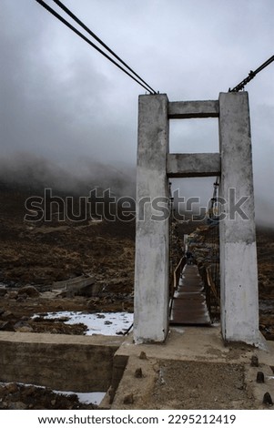 A big gate in front of an iron bridge on the way to Gurudongmar lake north Sikkim. Selective focus.