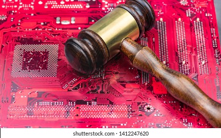 A big gavel over computer mainboard.Concept image law and judge for online internet