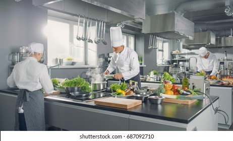 Big And Glamorous Restaurant Busy Kitchen, Chefs And Cooks Working On Their Dishes.