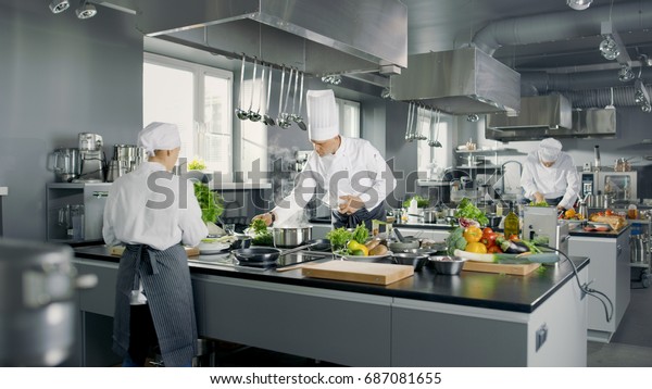 Big and Glamorous Restaurant Busy Kitchen,\
Chefs and Cooks Working on their\
Dishes.