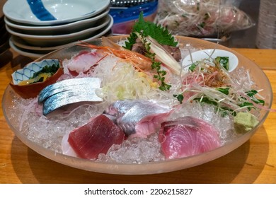 Big Glass Ice Bowl With Assorted Sashimi Pieces. Traditional Sashimi Dish In Japanese Fish Restaurant In Tokyo.