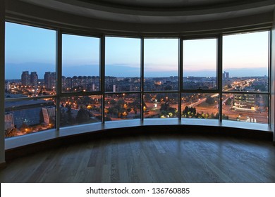 Big glass wall in oval living room with cityscape view - Shutterstock ID 136760885