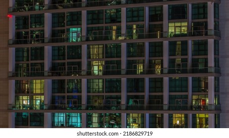 Big Glowing Windows In Modern Office And Residential Buildings Timelapse At Night, In Rows Of Windows Light Shines. Two Level Apartments