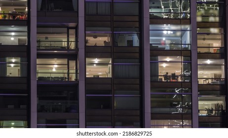 Big Glowing Windows In Modern Office And Residential Buildings Timelapse At Night, In Rows Of Windows Light Shines. Work Place At Home