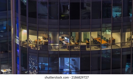 Big Glowing Windows In Modern Office Buildings Timelapse At Night, In Rows Of Windows Light Shines. Towers In Financial Center