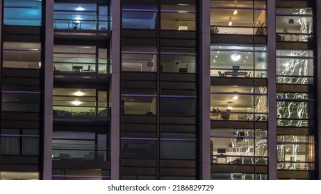 Big Glowing Windows In Modern Office And Residential Buildings Timelapse At Night, In Rows Of Windows Light Shines. Work Place At Home