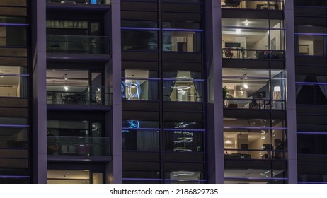 Big Glowing Windows In Modern Office And Residential Buildings Timelapse At Night, In Rows Of Windows Light Shines. Work Place At Home