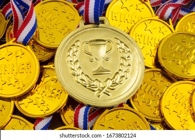 Big Gold Medal On Background Of Small Golden Medals.