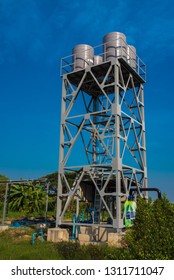 Big Gray Water Tank On The Metal Structure In The Park.