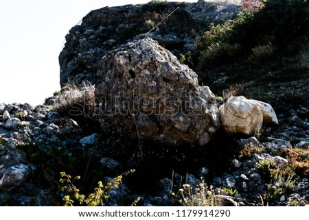 Similar – Beautiful young woman thinking and sitting on the rocks outdoors on the countryside