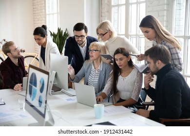 Big Group Of Business People Analyzing Marketing Reports On Computers Together. Crowded Shared Office Work Space. Busy Diverse Millennial Team Discussing Project, Brainstorming At Workplaces