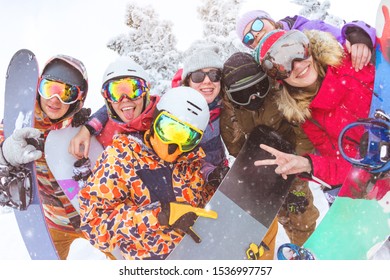 Big Group Of Friends Is Having Fun At Ski Resort. Happy Skiers And Snowboarders Are Taking Photo Together