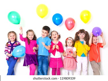 Big Group Of Happy Children With Balloons At White Wall