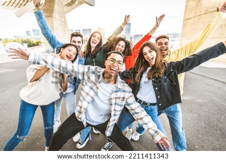 Big group of happy friends with arms up smiling at camera together - Multiracial young people having fun outdoors - Volunteer with hands up showing teamwork spirit - Community and friendship	
