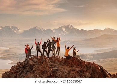 Big group of happy tourists are having fun and greeting sunset at mountain top. Active vacations concept - Powered by Shutterstock