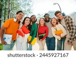 Big group of real students smiling and looking at camera together at high school. Happy teenagers laughing at university campus. Multiracial classmates standing outside. Best friends having fun. High