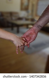 Big, Hairy  Man's Hand Is Pulling Small Girl's Hand.