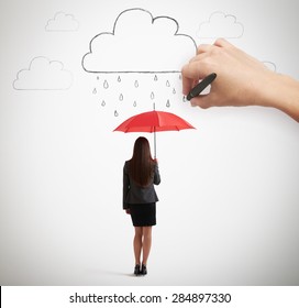 big hand drawing clouds with drops, businesswoman with red umbrella standing under rain over light grey background - Powered by Shutterstock