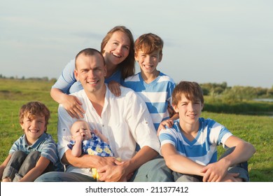 Big Happy Family. Parents With Four Children In Countryside Outdoors