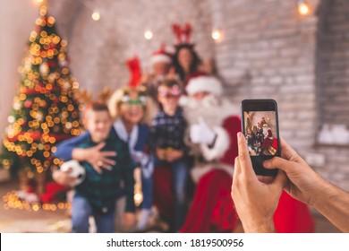 Big Happy Family Spending Christmas Day All Together At Home, Gathered Around Nicely Decorated Christmas Tree, Having Fun Taking Photos With Santa Claus