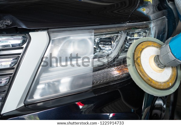 Big headlight cleaning\
on the car with power buffer machine at service station ,Before and\
after cleaning